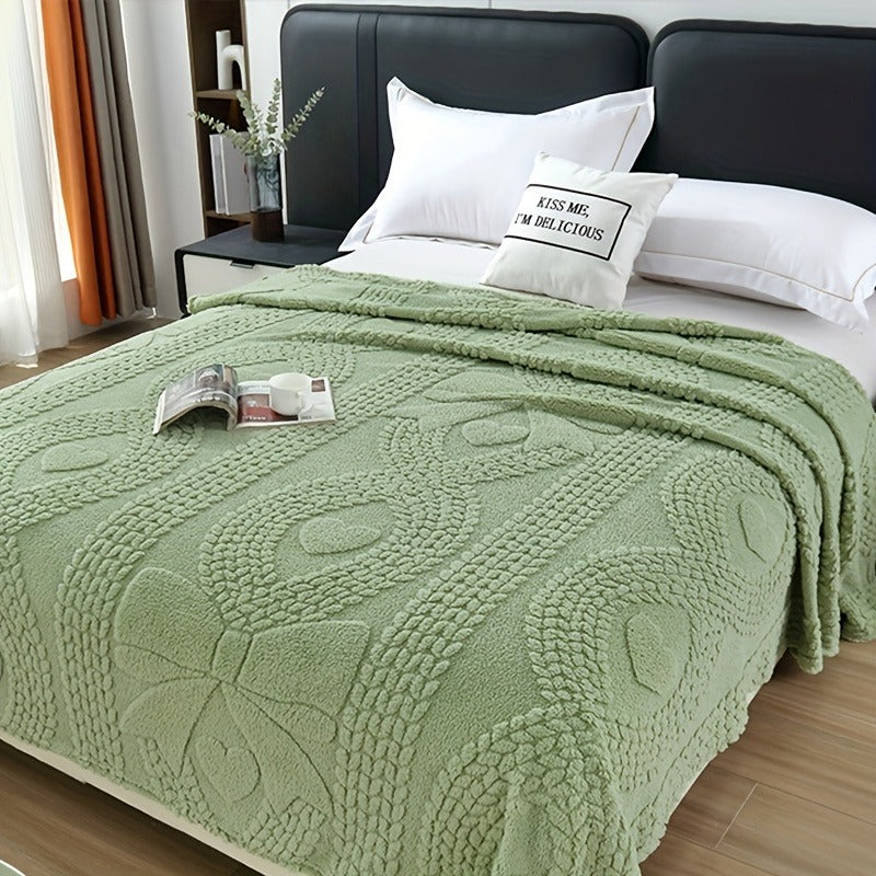 Plaid jacquard torsadé vert sur un lit Image