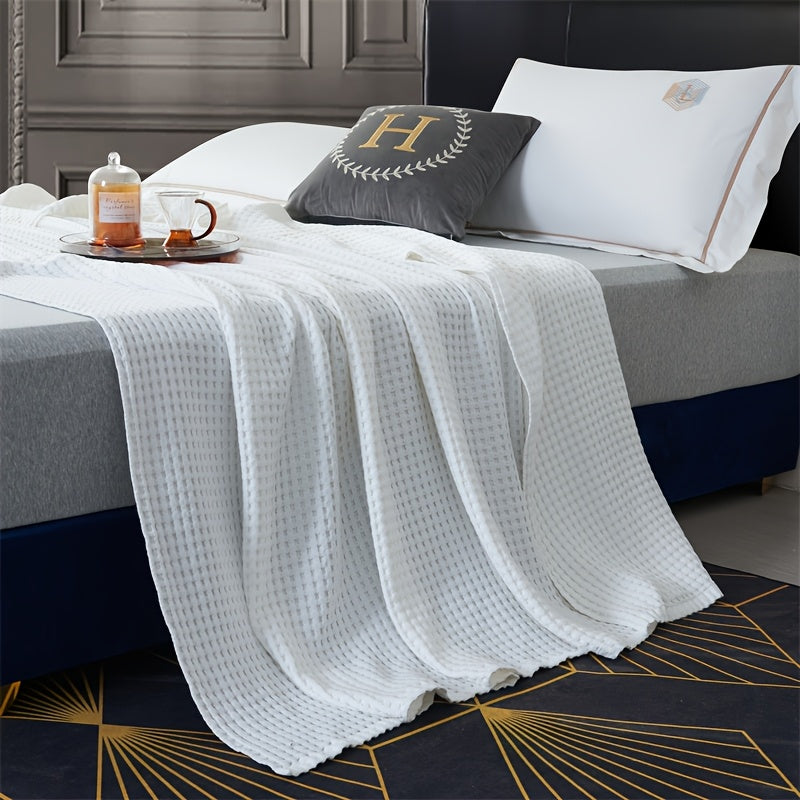 Plaid nid d'abeille en coton blanc sur un lit Image