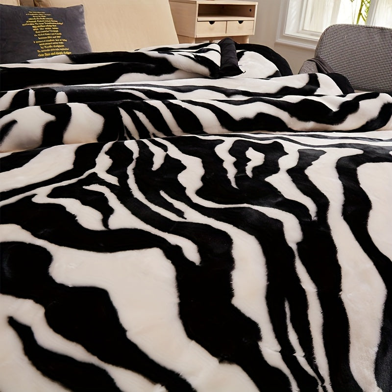 Plaid imprimé zèbre noir et blanc sur un lit